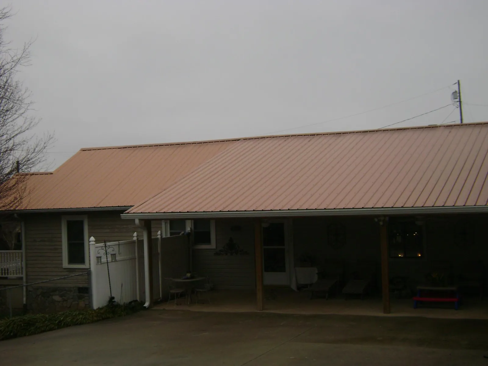 Copper toned metal roof over a wide covered patio in Riverside